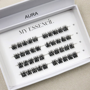 Coffret AURA ouvert en gros plan, clusters précollés tailles 10 à 14 mm